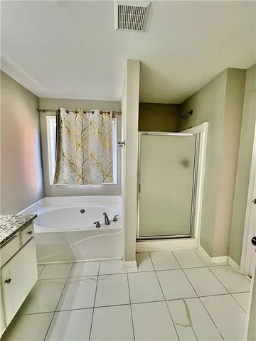 a view of a refrigerator in kitchen and white cabinets
