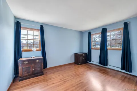 an empty room with windows and closet