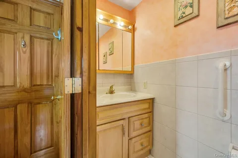 a bathroom with a granite countertop sink a mirror and shower
