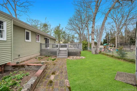a view of a house with backyard sitting area and garden