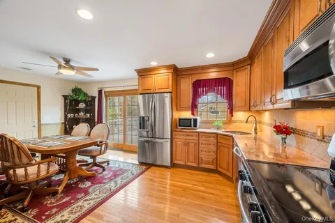 a kitchen with stainless steel appliances granite countertop a refrigerator and a stove top oven