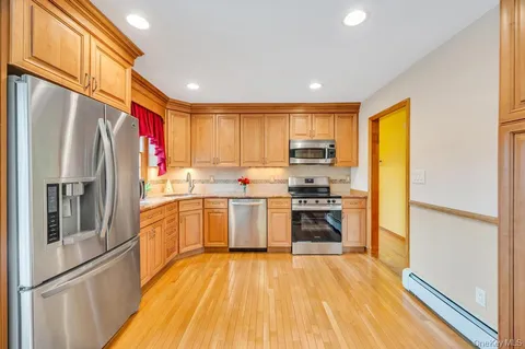a kitchen with stainless steel appliances granite countertop a refrigerator stove and sink