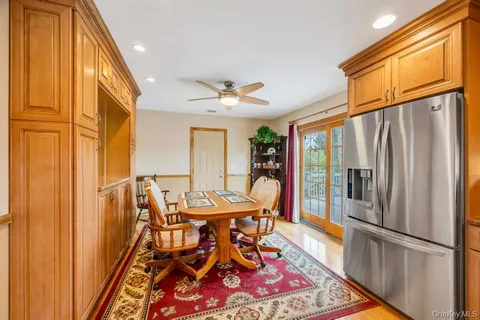 a dining room with chandelier and wooden floor