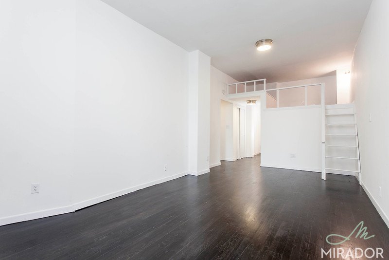65 4th Avenue, Unit 6C Manhattan, NY 10003 - Photo 3 of 11 a view of an empty room with wooden floor