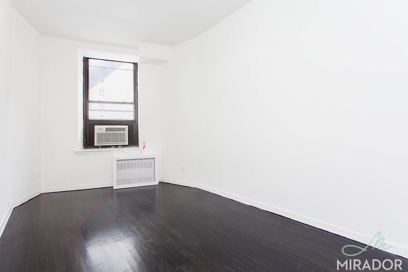 65 4th Avenue, Unit 6C Manhattan, NY 10003 - Photo 4 of 11 a view of a small space with wooden floor and a window