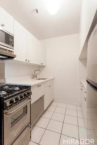 a kitchen with a stove a sink and a microwave