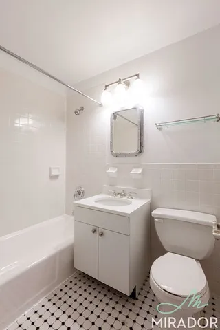 a bathroom with a toilet a sink and a bathtub