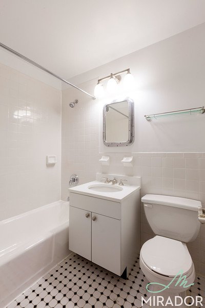 65 4th Avenue, Unit 6C Manhattan, NY 10003 - Photo 6 of 11 a bathroom with a toilet a sink and a bathtub