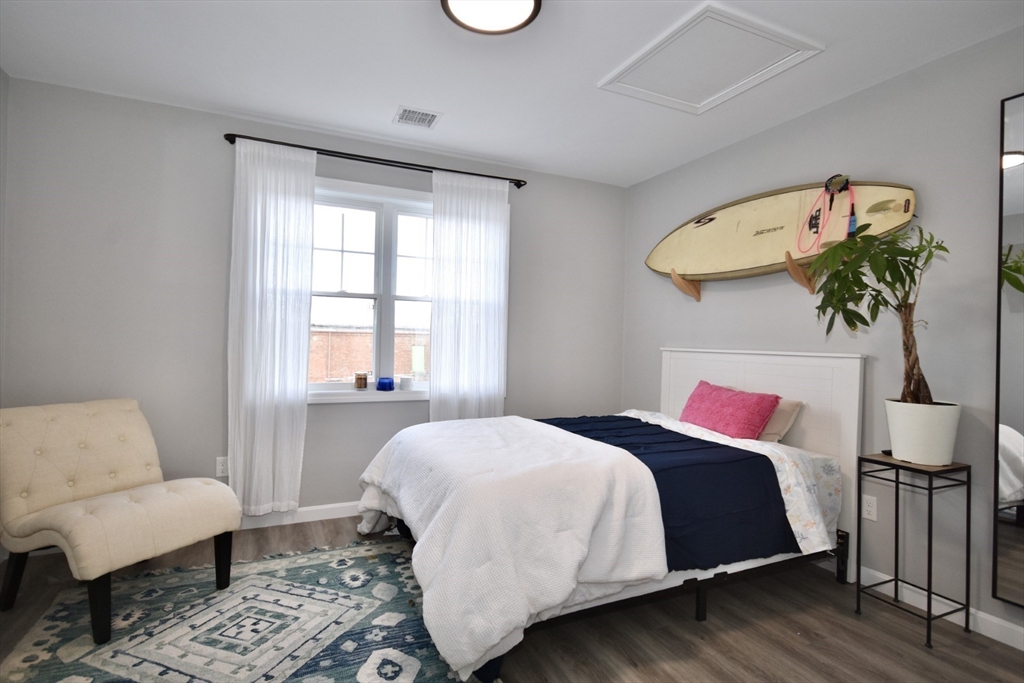 550 Spring Street, Unit 2 Fall River, MA 02721 - Photo 9 of 13 a bedroom with a bed and a couch
