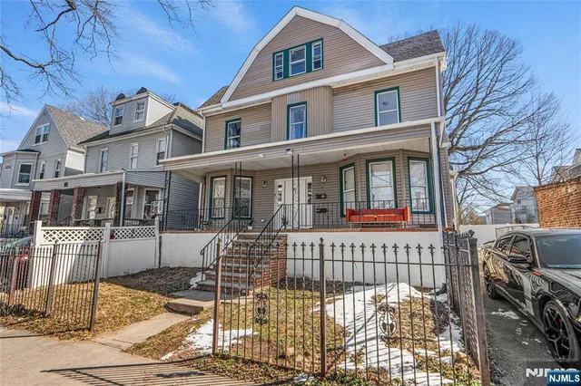 a view of a brick house with many windows