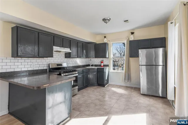 a kitchen with a refrigerator sink and microwave