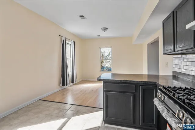 a kitchen with stainless steel appliances granite countertop a stove and a sink