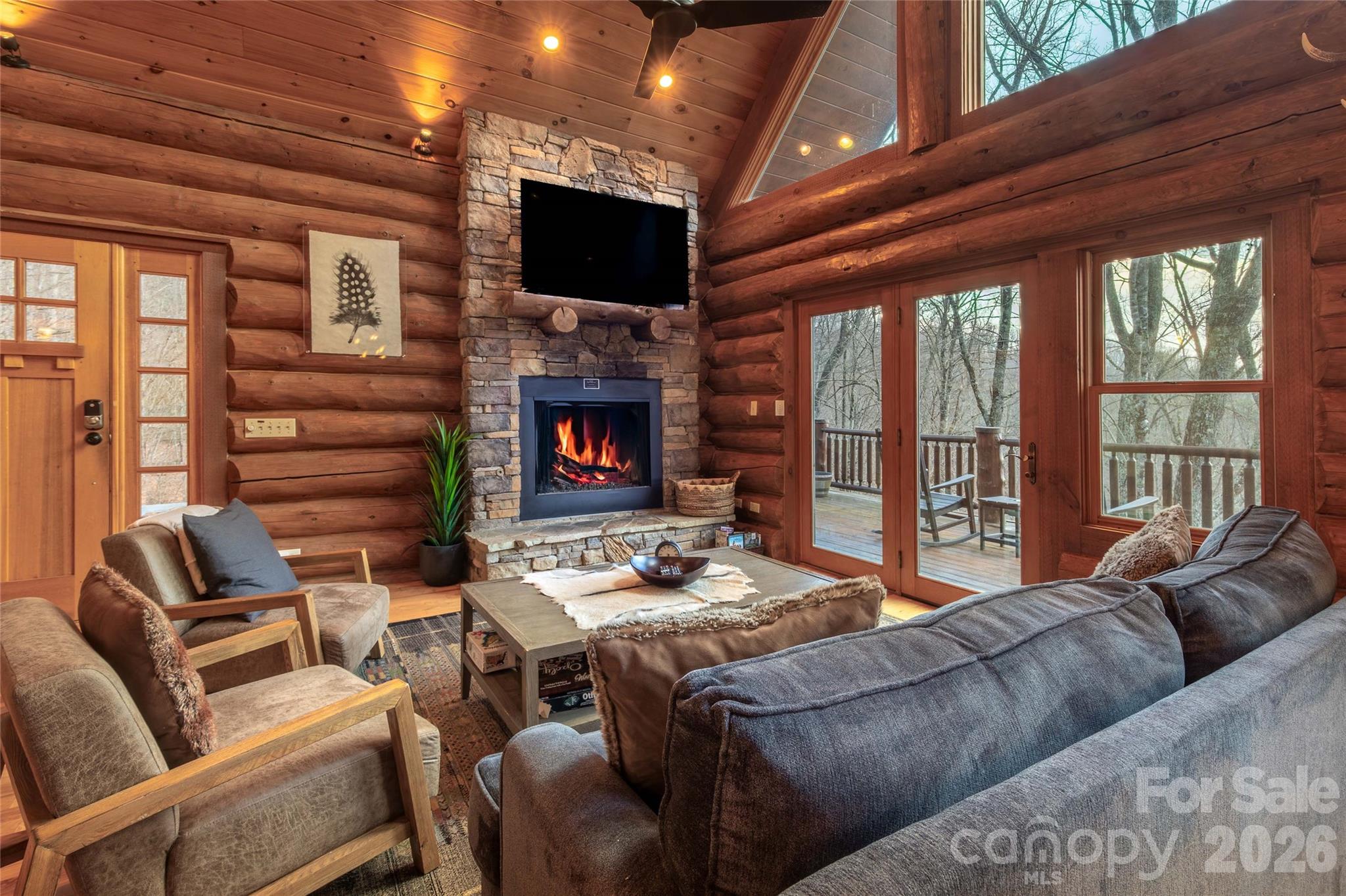 1391 Still Branch Road Sylva, NC 28779 - Photo 11 of 40 a living room with furniture a flat screen tv and a fireplace
