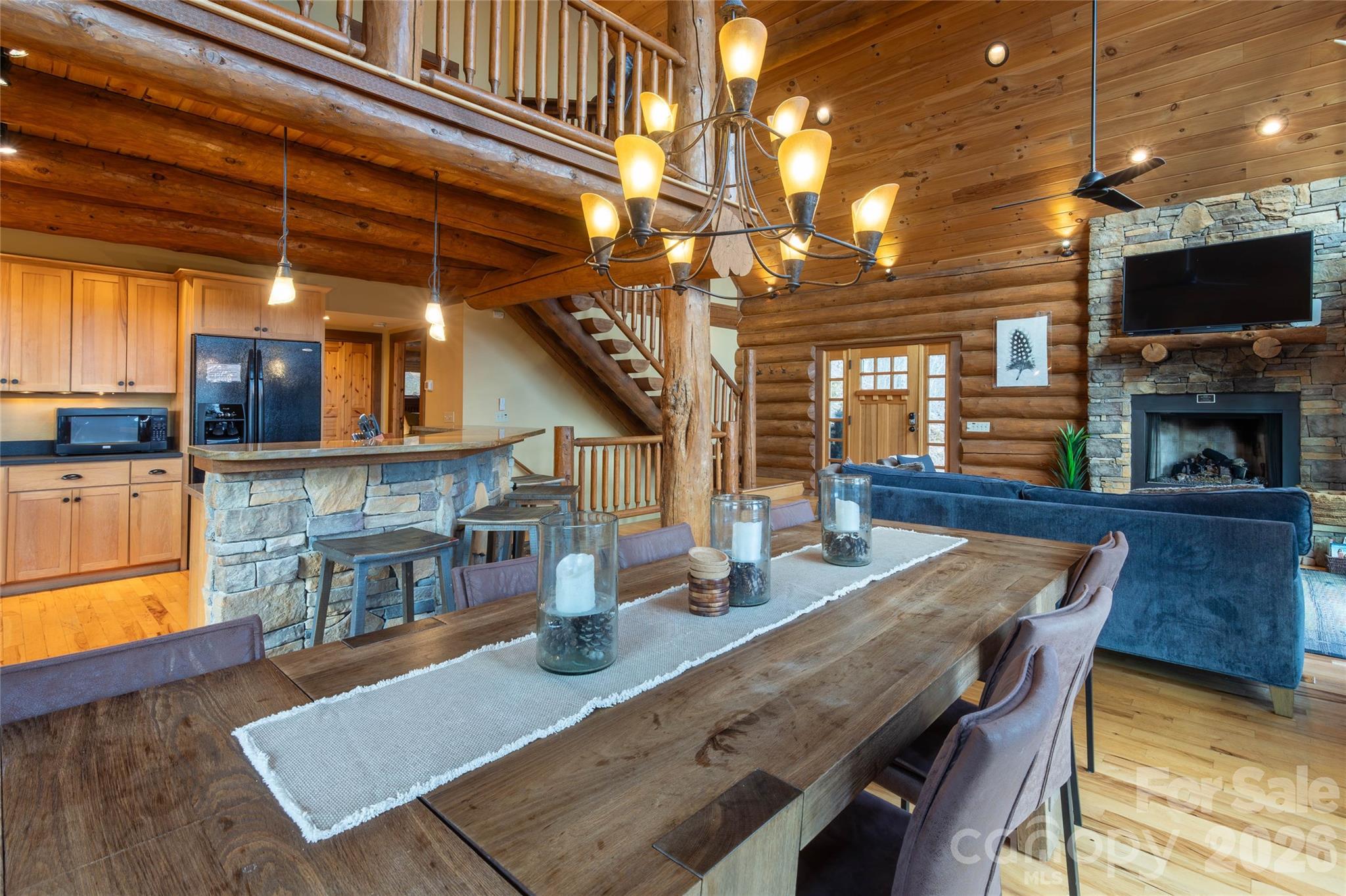 1391 Still Branch Road Sylva, NC 28779 - Photo 13 of 40 a dining room with furniture a fireplace and wooden floor