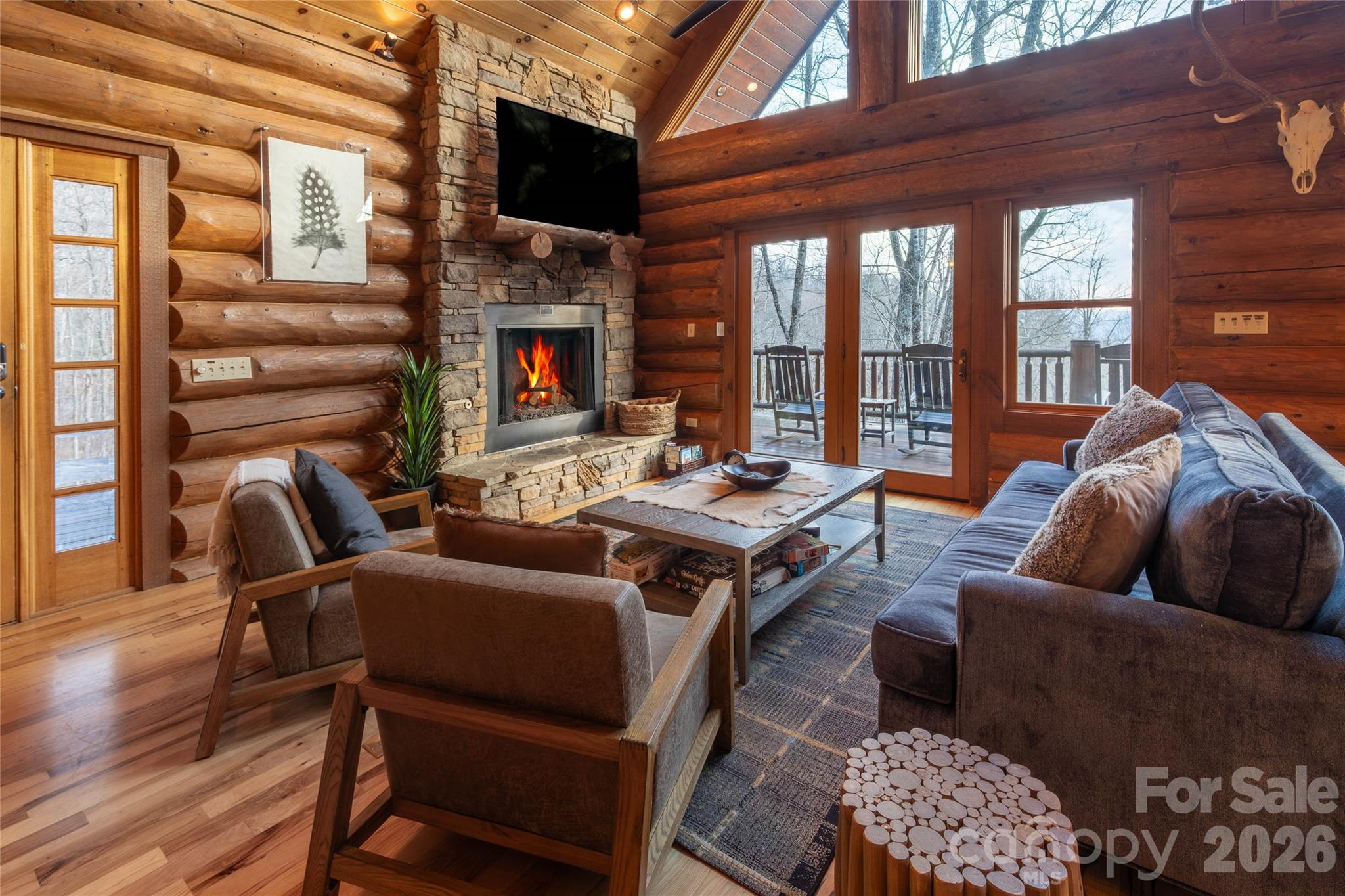 1391 Still Branch Road Sylva, NC 28779 - Photo 14 of 40 a living room with furniture a flat screen tv and a fireplace
