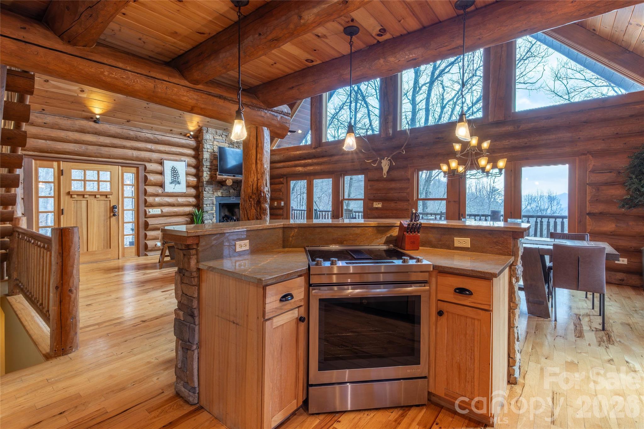 1391 Still Branch Road Sylva, NC 28779 - Photo 17 of 40 a kitchen with a stove top oven cabinets and a table