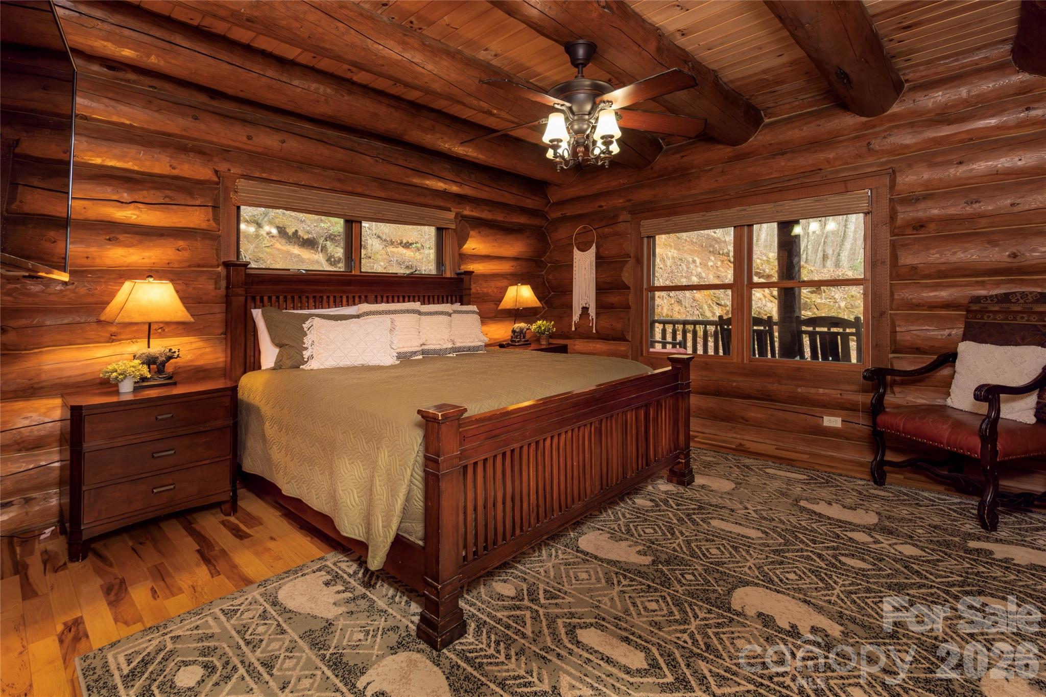 1391 Still Branch Road Sylva, NC 28779 - Photo 19 of 40 a bed sitting in a spacious bedroom next to a window