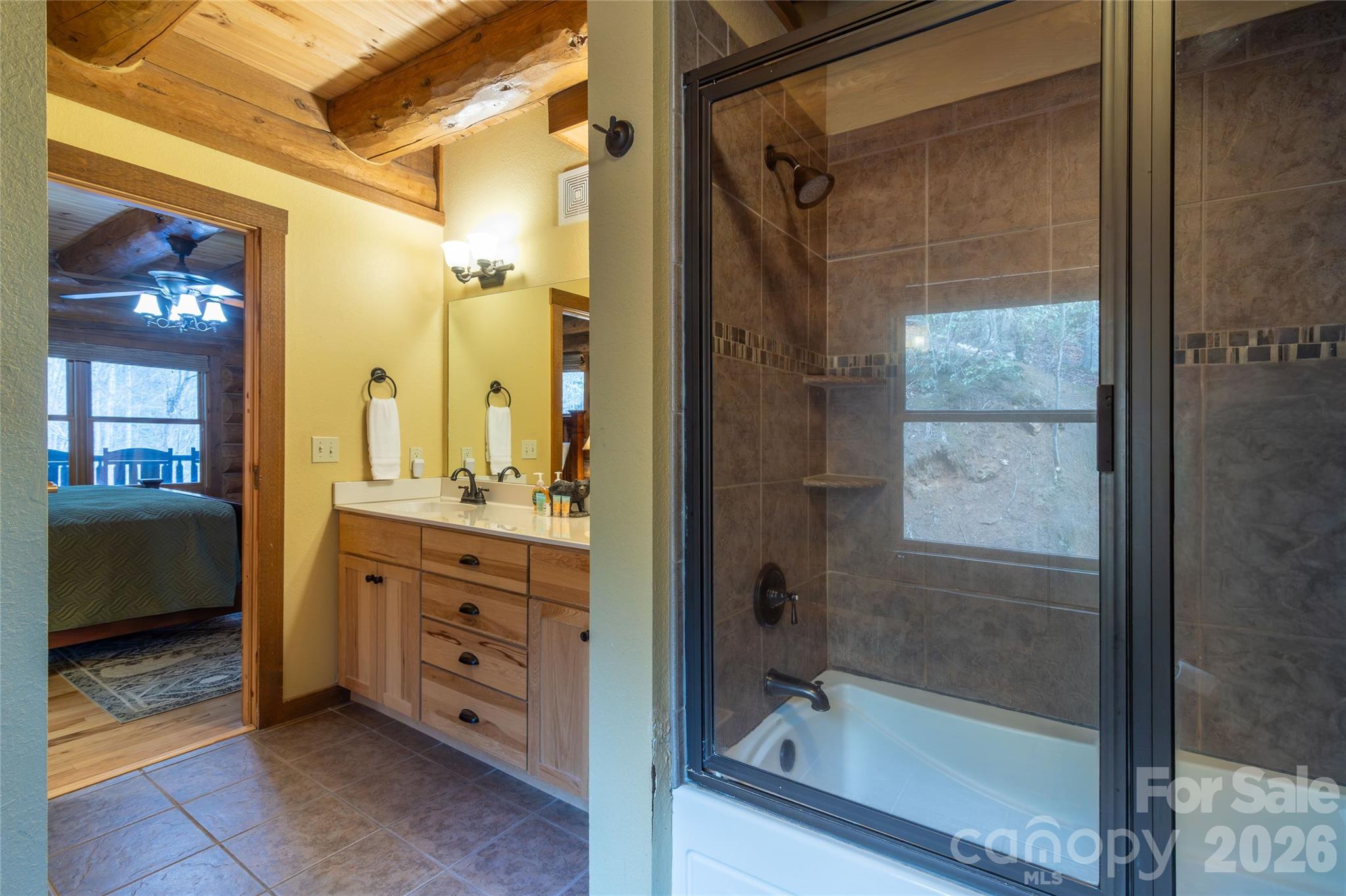 1391 Still Branch Road Sylva, NC 28779 - Photo 21 of 40 a bathroom with a shower sink and mirror