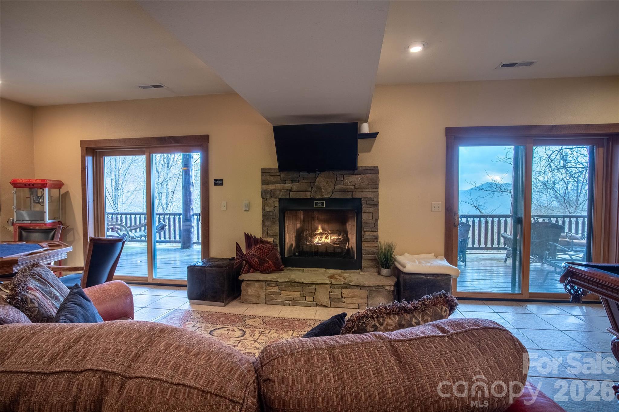 1391 Still Branch Road Sylva, NC 28779 - Photo 28 of 40 a bedroom with a large bed and a fireplace