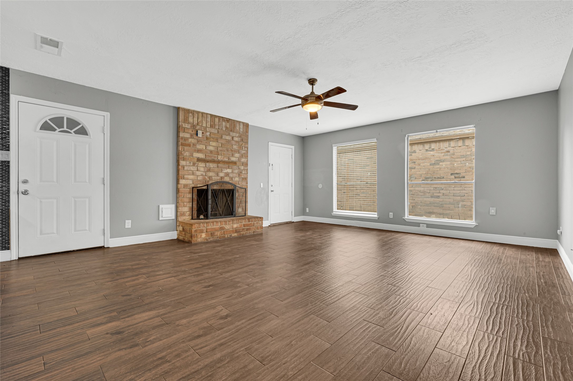 4170 Amir Street Houston, TX 77072 - Photo 3 of 18 an empty room with wooden floor chandelier and windows