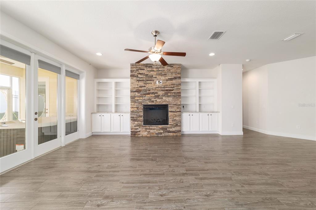 6429 Southwest 45th Avenue Ocala, FL 34474 - Photo 11 of 56 a view of empty room with wooden floor and fireplace