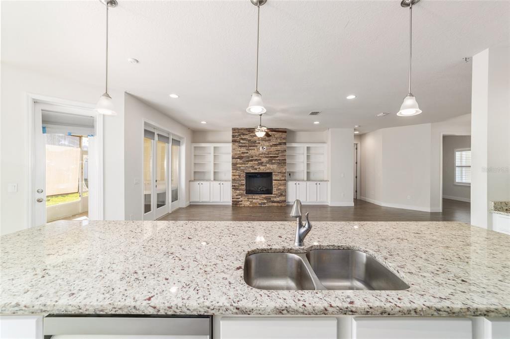 6429 Southwest 45th Avenue Ocala, FL 34474 - Photo 15 of 56 a kitchen with granite countertop a sink a counter top space and living room view