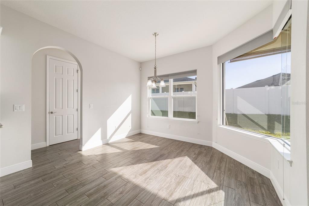6429 Southwest 45th Avenue Ocala, FL 34474 - Photo 18 of 56 a view of an empty room with wooden floor and a window