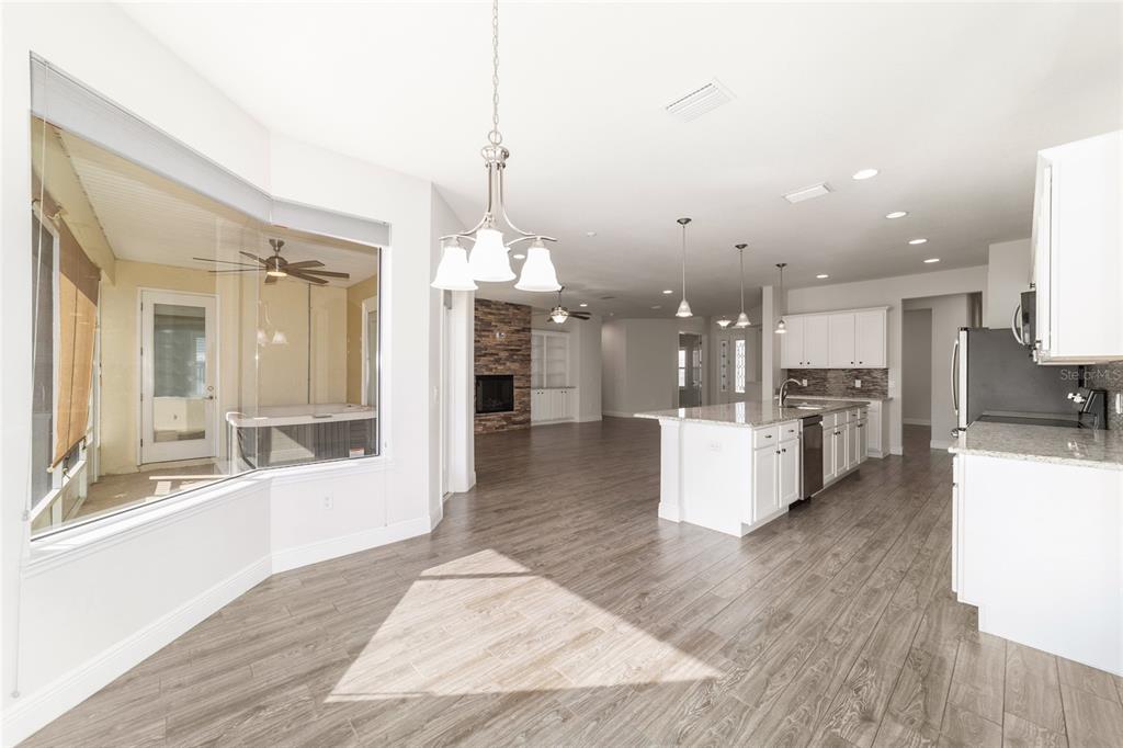 6429 Southwest 45th Avenue Ocala, FL 34474 - Photo 20 of 56 a view of a kitchen with kitchen island stainless steel appliances wooden floor and a chandelier