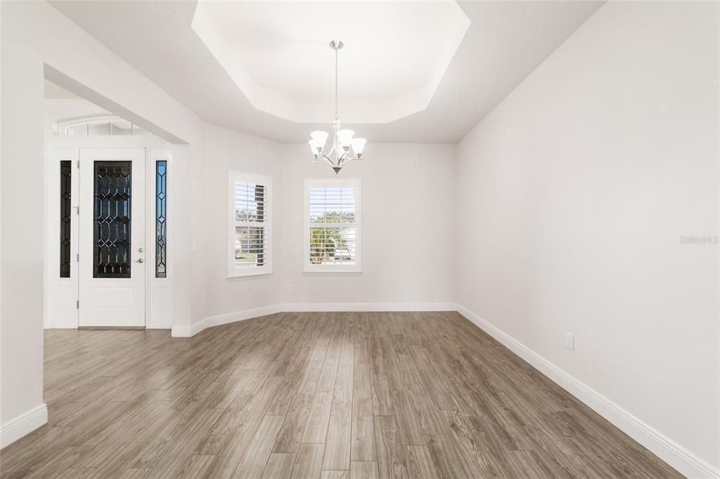 6429 Southwest 45th Avenue Ocala, FL 34474 - Photo 21 of 56 an empty room with wooden floor and windows