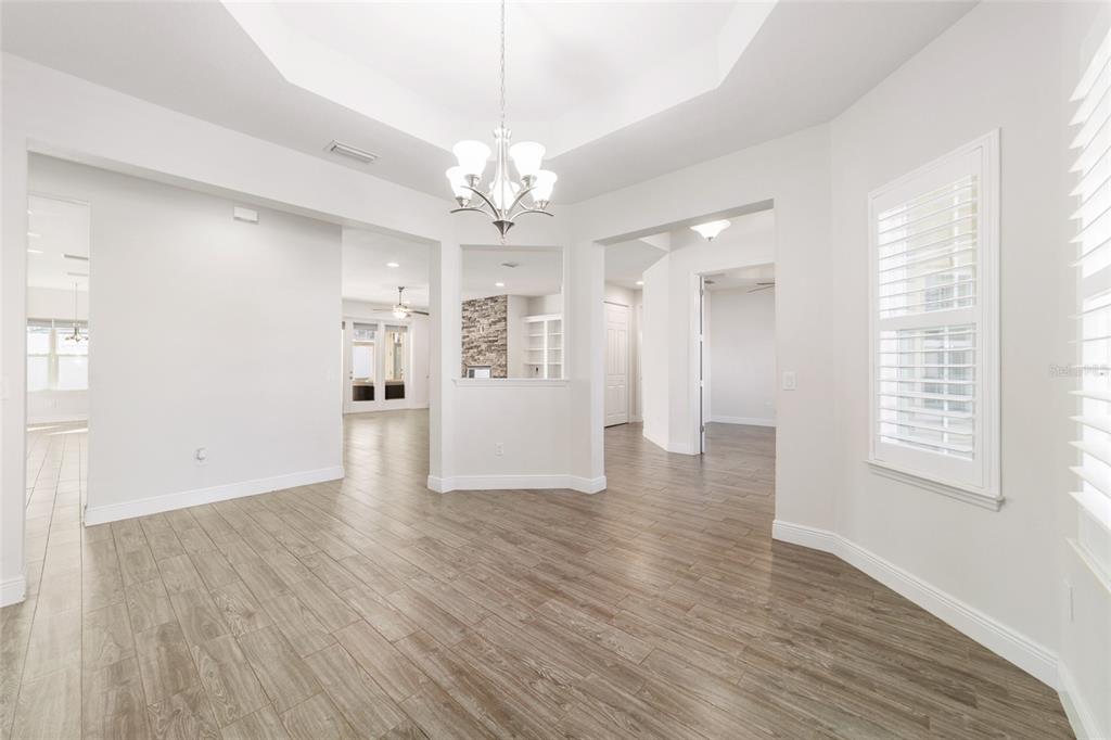 6429 Southwest 45th Avenue Ocala, FL 34474 - Photo 23 of 56 an empty room with wooden floor and windows