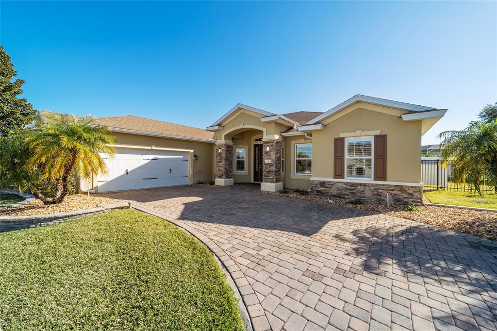 6429 Southwest 45th Avenue Ocala, FL 34474 - Photo 3 of 56 a front view of a house with a yard