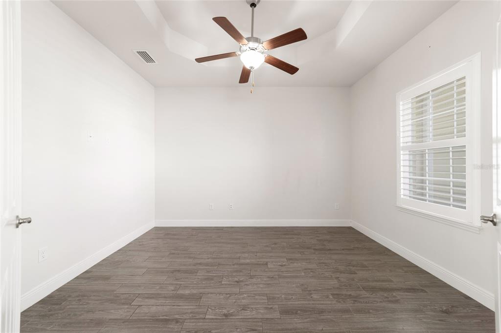 6429 Southwest 45th Avenue Ocala, FL 34474 - Photo 32 of 56 an empty room with wooden floor and windows