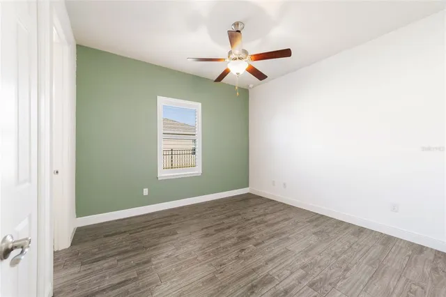 a bathroom with a granite countertop sink a toilet and bathtub