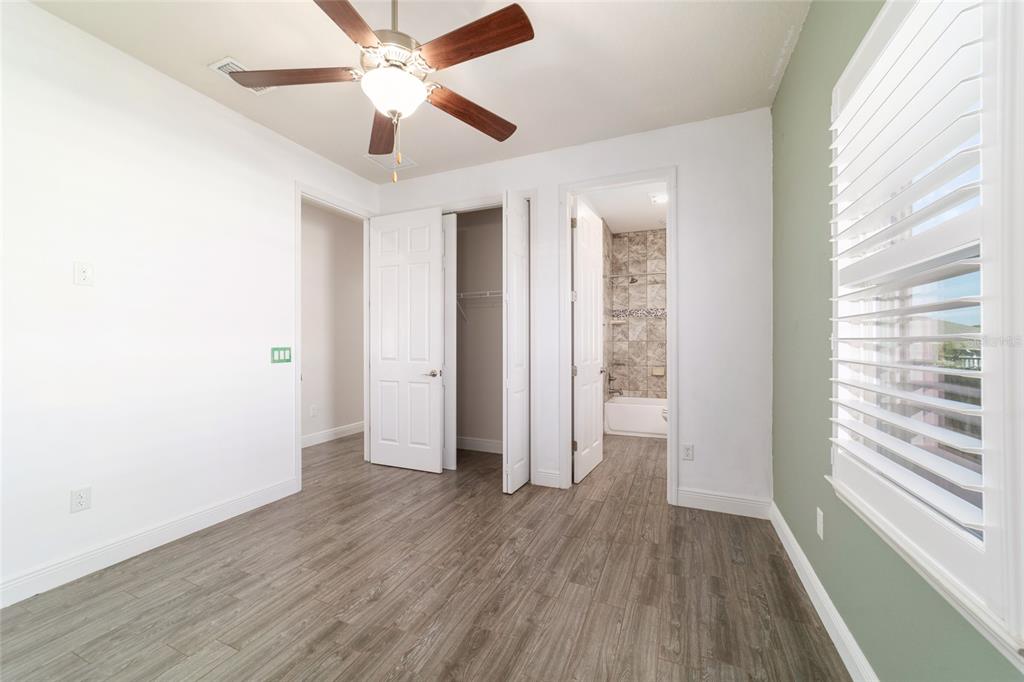 6429 Southwest 45th Avenue Ocala, FL 34474 - Photo 36 of 56 a view of an empty room with a window and wooden floor