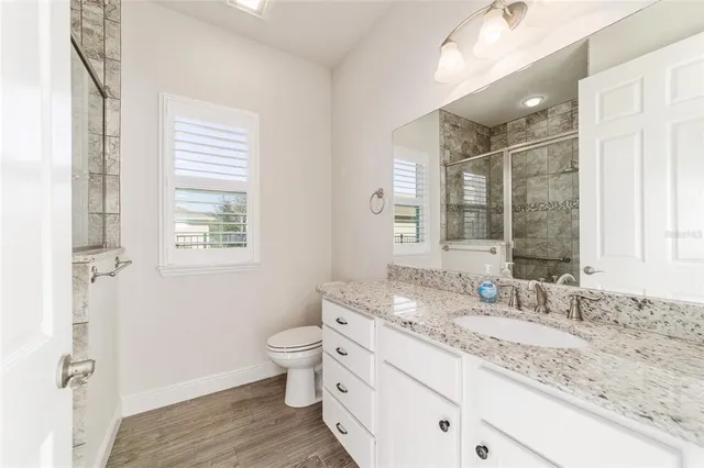 a bathroom with a double vanity sink and a large mirror