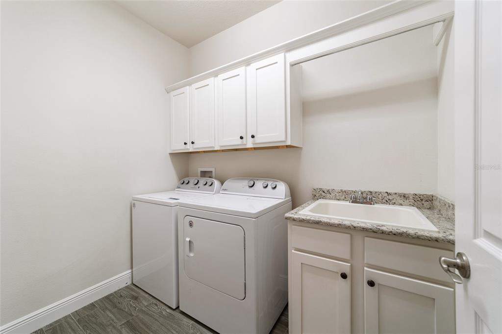 6429 Southwest 45th Avenue Ocala, FL 34474 - Photo 42 of 56 a utility room with sink dryer and washer