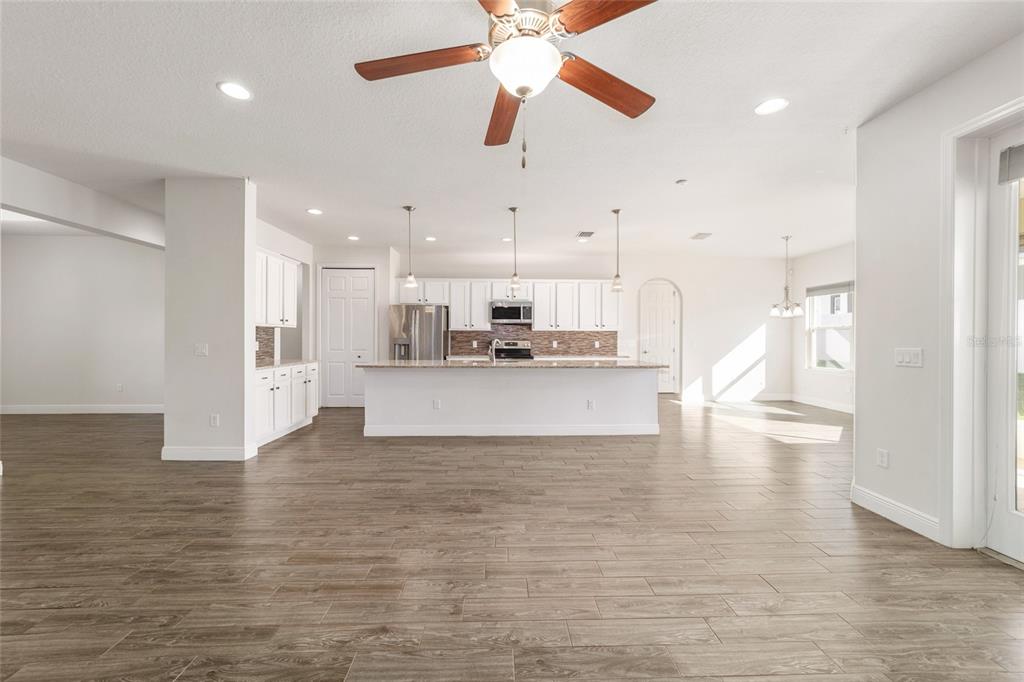 6429 Southwest 45th Avenue Ocala, FL 34474 - Photo 9 of 56 a view of kitchen dining table chairs microwave and cabinets