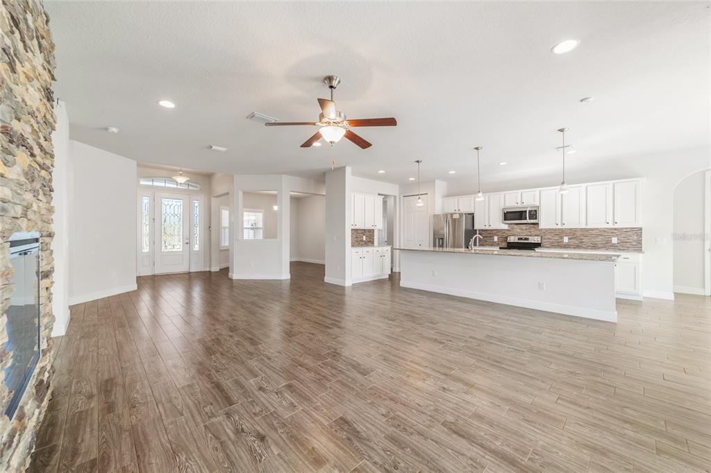 6429 Southwest 45th Avenue Ocala, FL 34474 - Photo 10 of 56 a view of kitchen with refrigerator stove and wooden floor