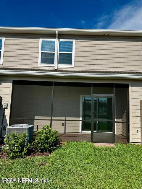 389 Belfort Court St. Augustine, FL 32092 - Photo 24 of 24 a view of a backyard with potted plants and a large window