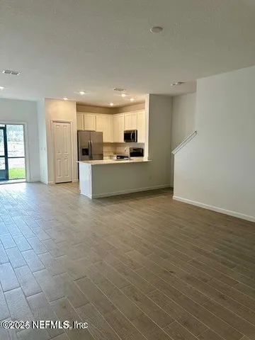 a kitchen with stainless steel appliances granite countertop a refrigerator stove microwave and sink