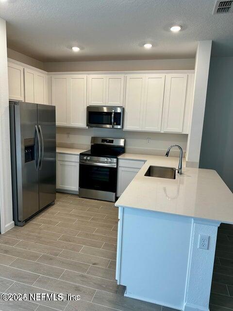 389 Belfort Court St. Augustine, FL 32092 - Photo 6 of 24 a kitchen with stainless steel appliances granite countertop a refrigerator stove microwave and sink