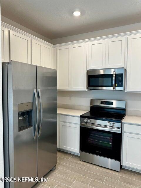 389 Belfort Court St. Augustine, FL 32092 - Photo 7 of 24 a kitchen with cabinets and stainless steel appliances