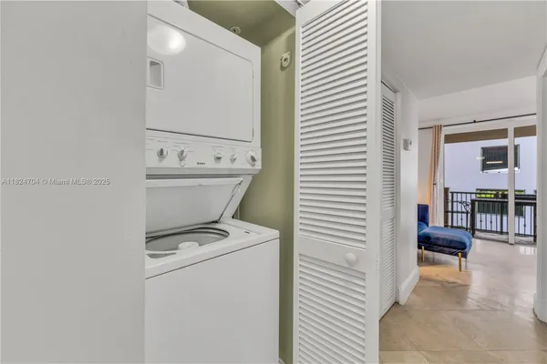 a large white bedroom with a large bed and furniture