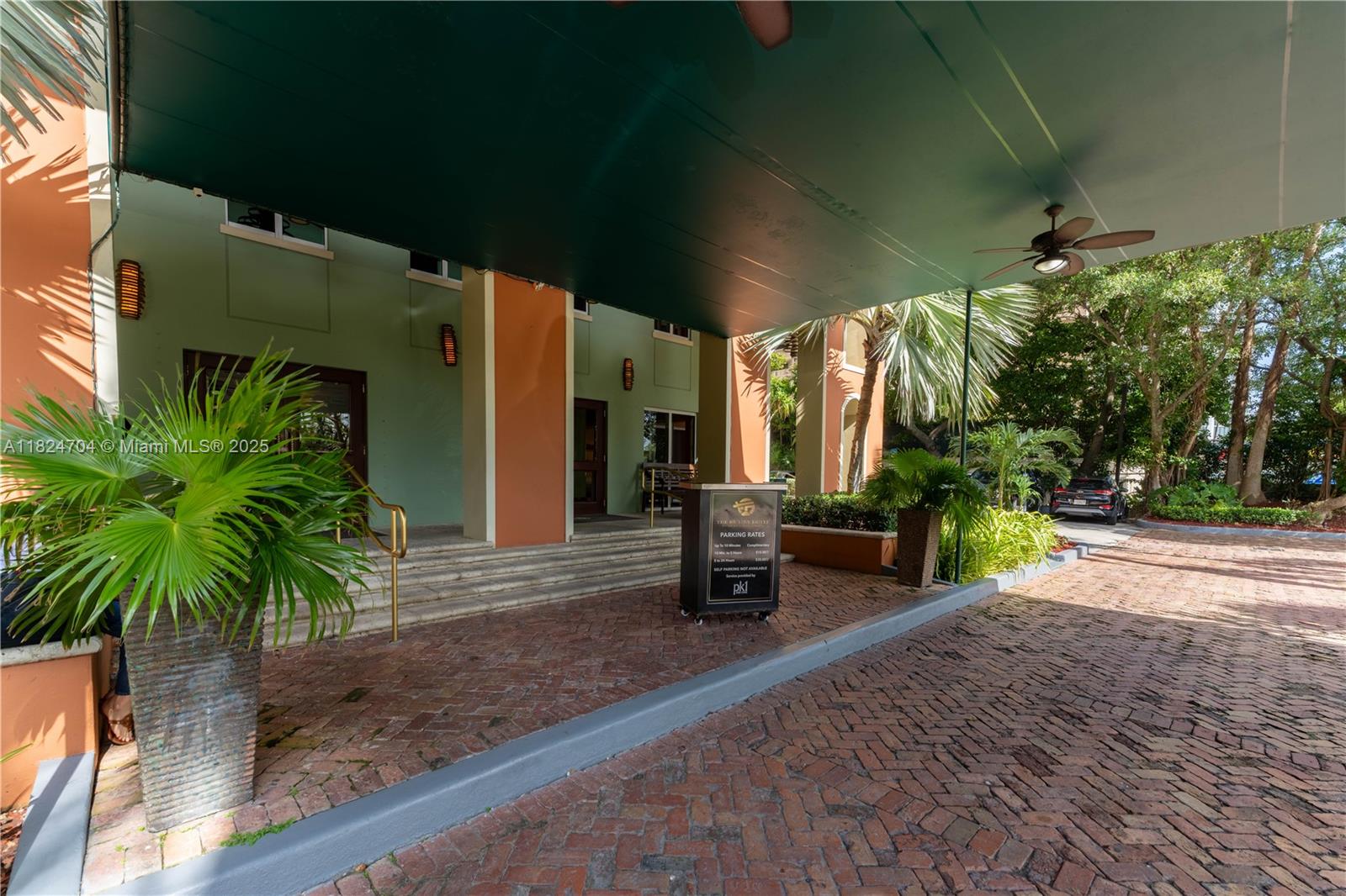 2951 South Bayshore Drive, Unit 717 Miami, FL 33133 - Photo 23 of 31 a view of a porch with furniture and a yard