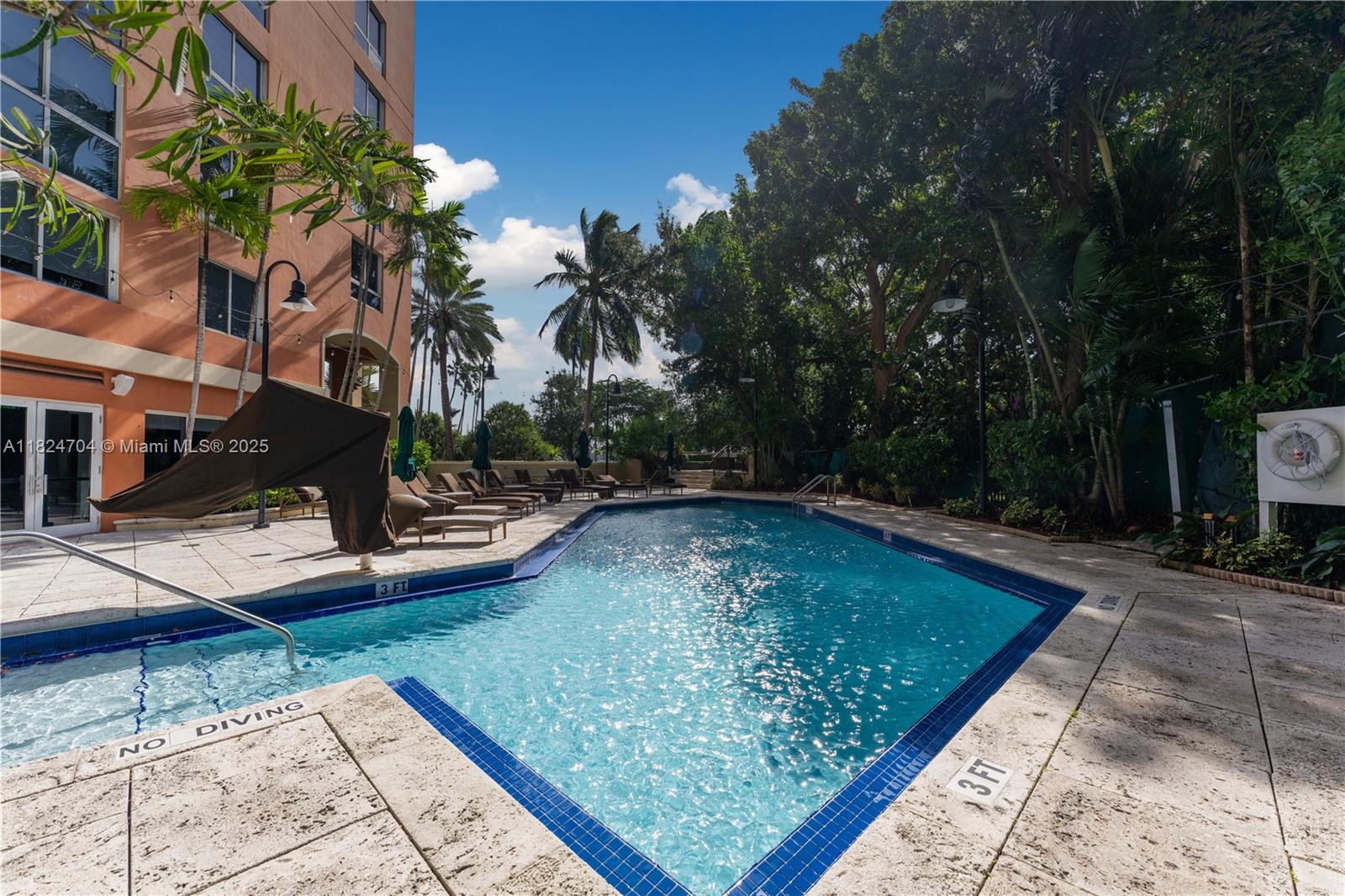 2951 South Bayshore Drive, Unit 717 Miami, FL 33133 - Photo 26 of 31 a view of a swimming pool with a patio
