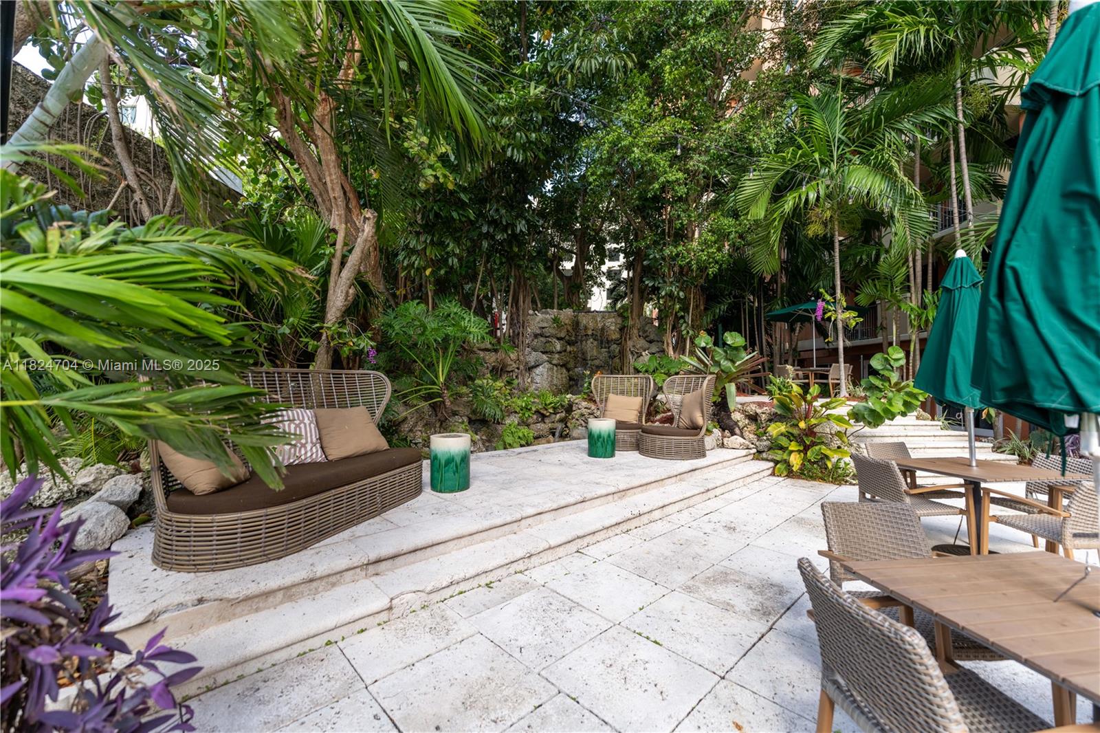 2951 South Bayshore Drive, Unit 717 Miami, FL 33133 - Photo 27 of 31 a view of backyard with outdoor seating and plants