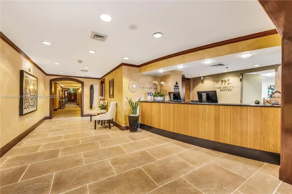 a view of a lobby with wooden floor and furniture
