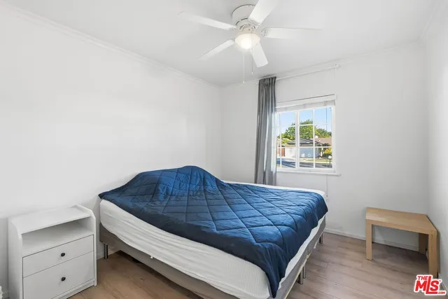 a view of bedroom with a bed and a ceiling fan
