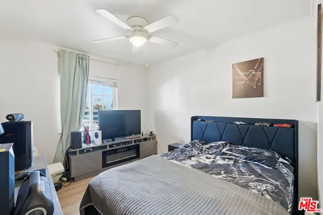 a bedroom with a bed and a flat screen tv