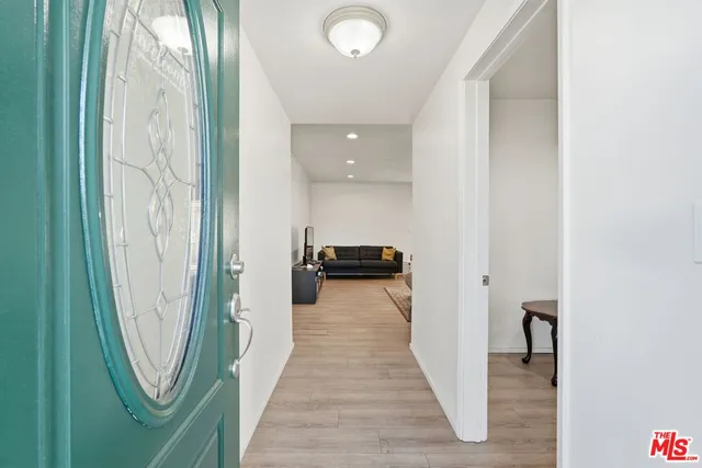 a view of a hallway with wooden floor